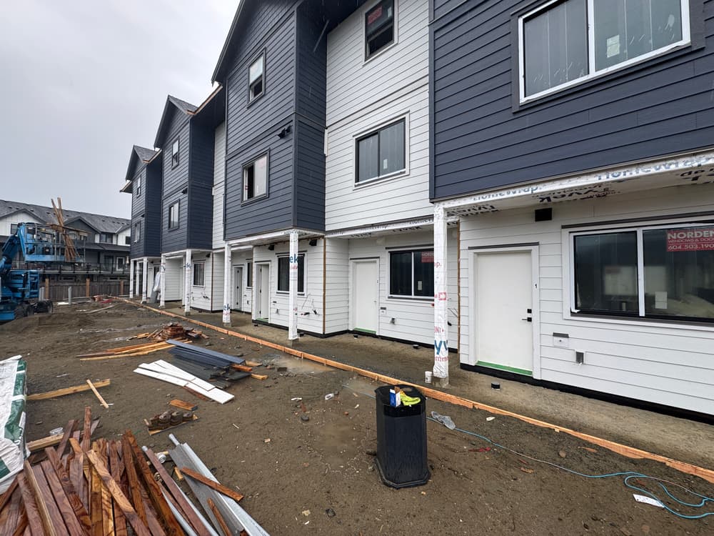 Newly constructed multi-family residential buildings with exterior work in progress.
